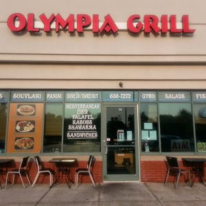 The Olympia Grill storefront, complete with our sign and window decals highlighting our Greek and Lebanese specialty dishes.